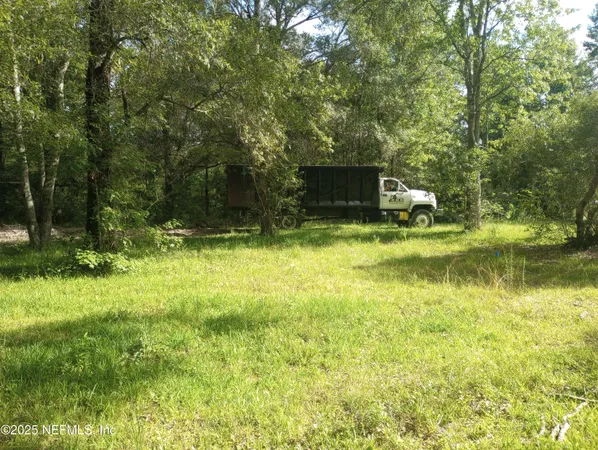a view of a backyard with swimming pool