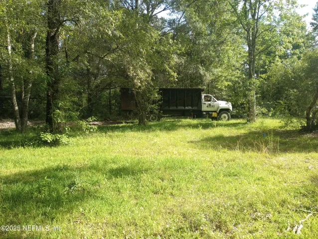 a view of a backyard with swimming pool