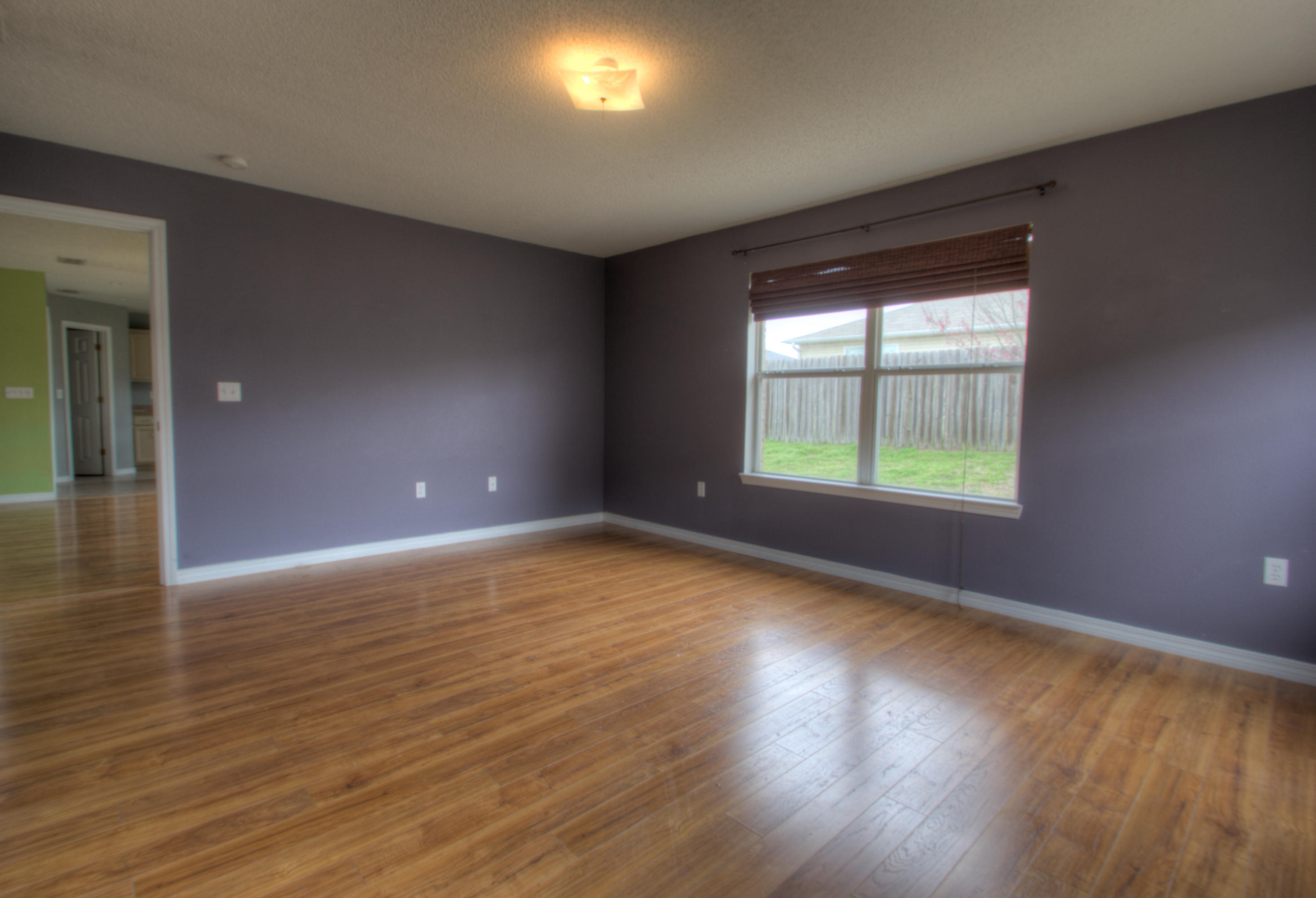 219 Limestone Circle Crestview, FL 32539 - Photo 17 of 31 an empty room with wooden floor and windows