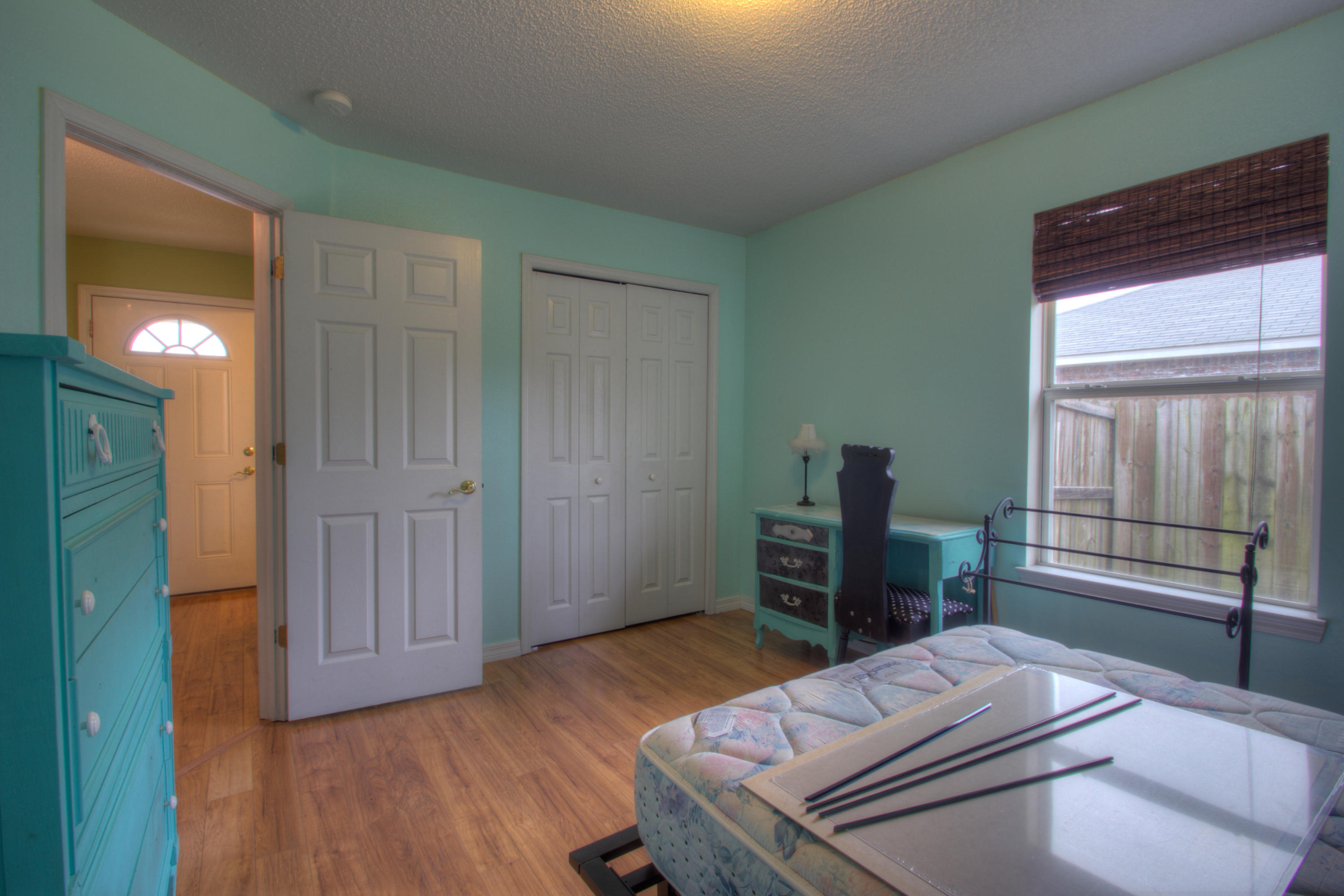 219 Limestone Circle Crestview, FL 32539 - Photo 25 of 31 a bedroom with a bed and wooden floor