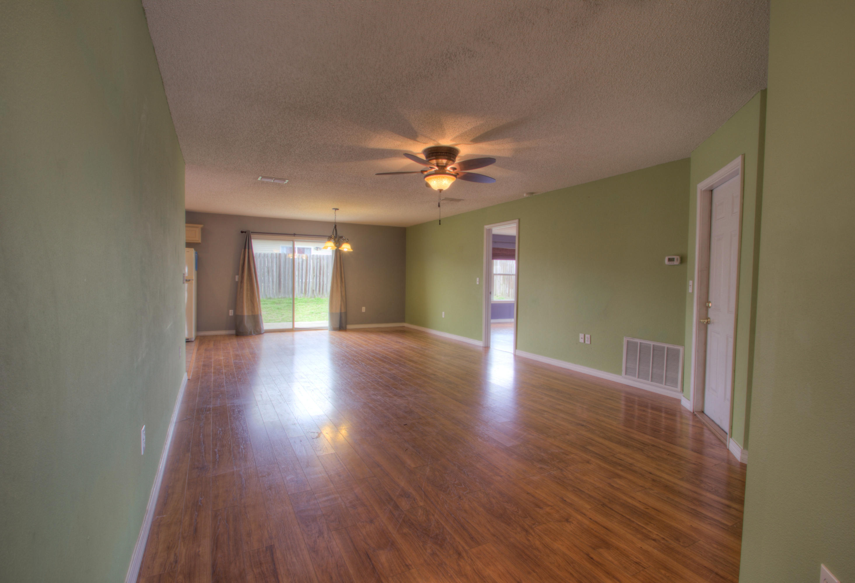219 Limestone Circle Crestview, FL 32539 - Photo 3 of 31 a view of an empty room with window and wooden floor