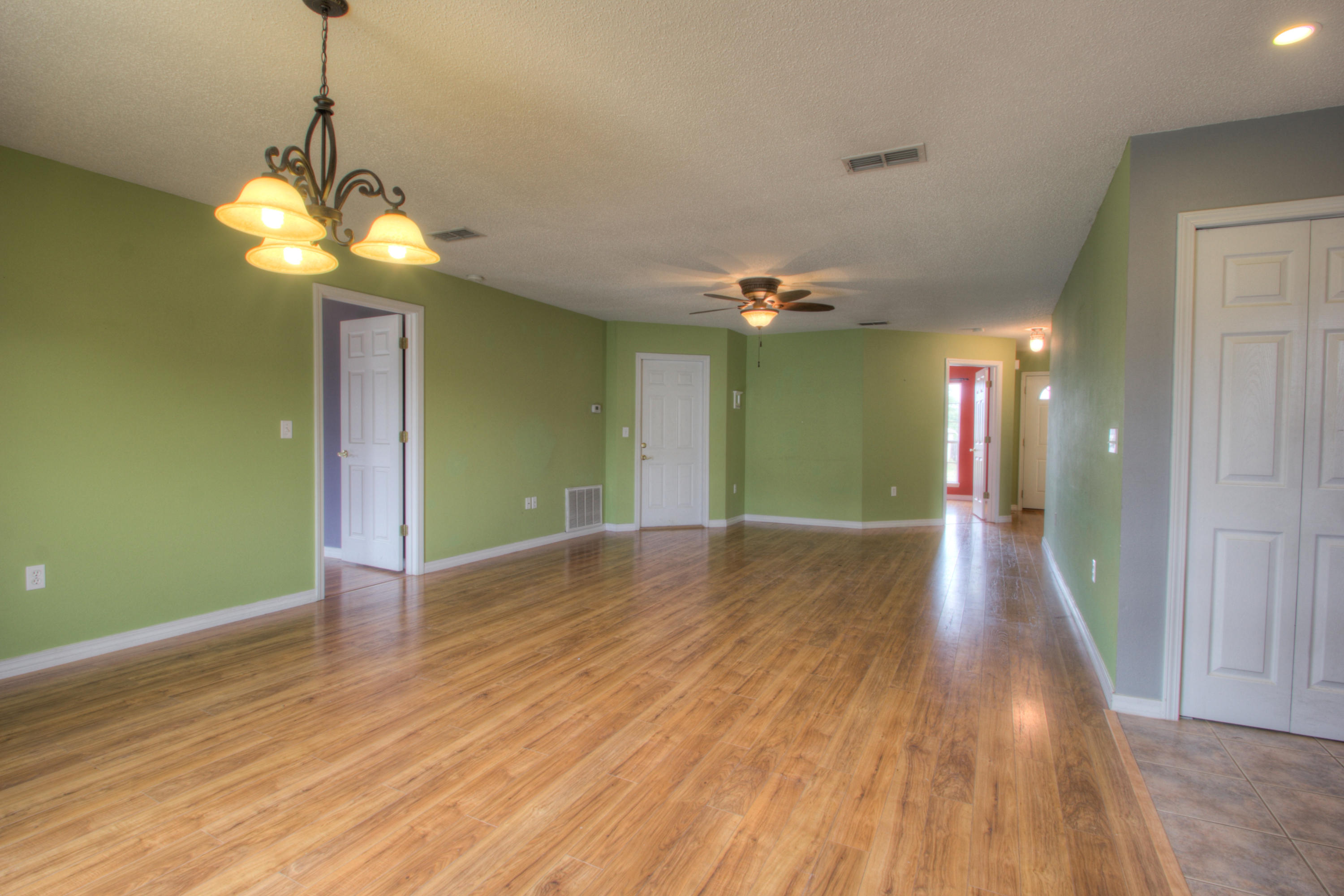 219 Limestone Circle Crestview, FL 32539 - Photo 6 of 31 a view of a livingroom with a chandelier fan and a hardwood floor