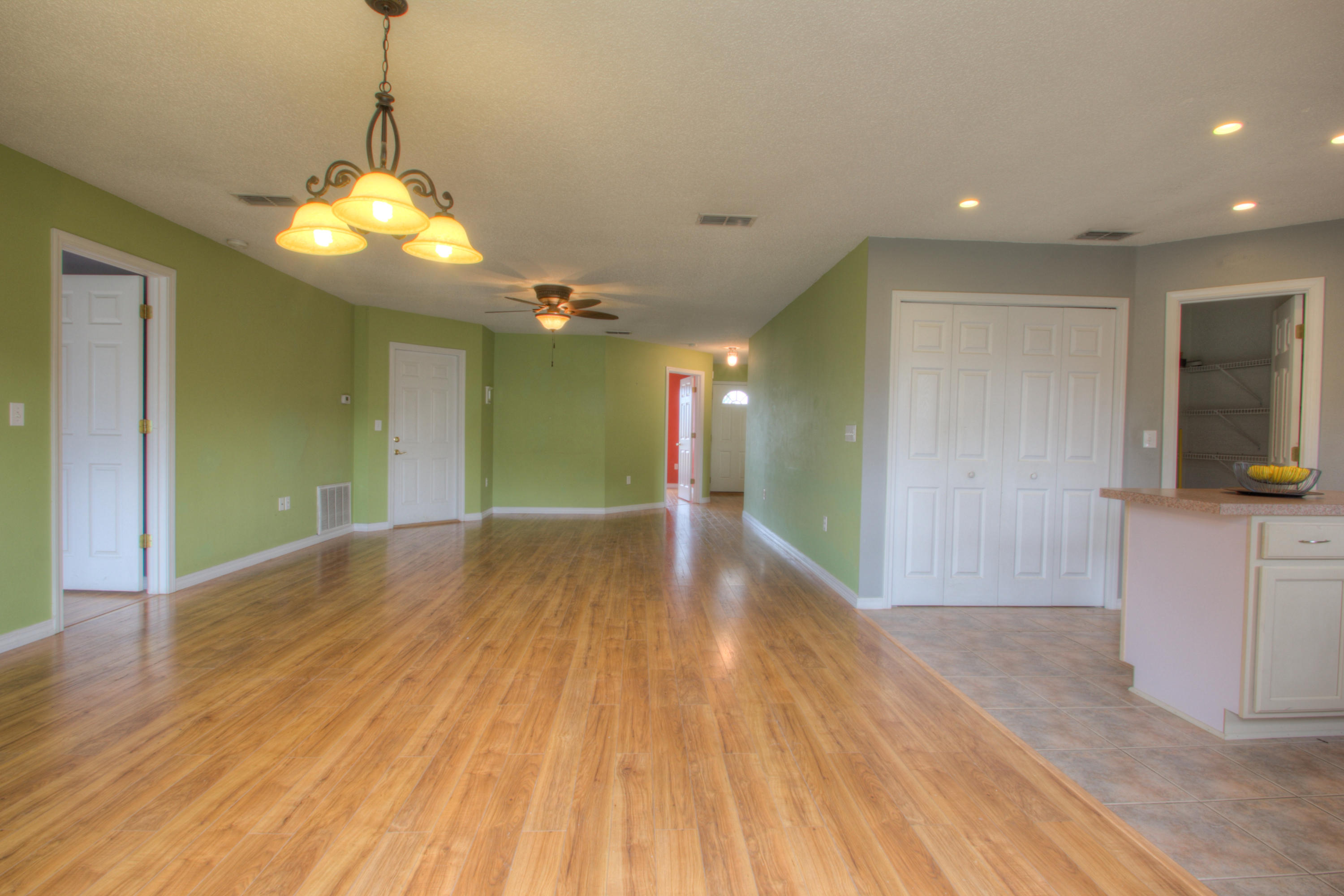 219 Limestone Circle Crestview, FL 32539 - Photo 7 of 31 a view of a livingroom with a chandelier fan and wooden floor