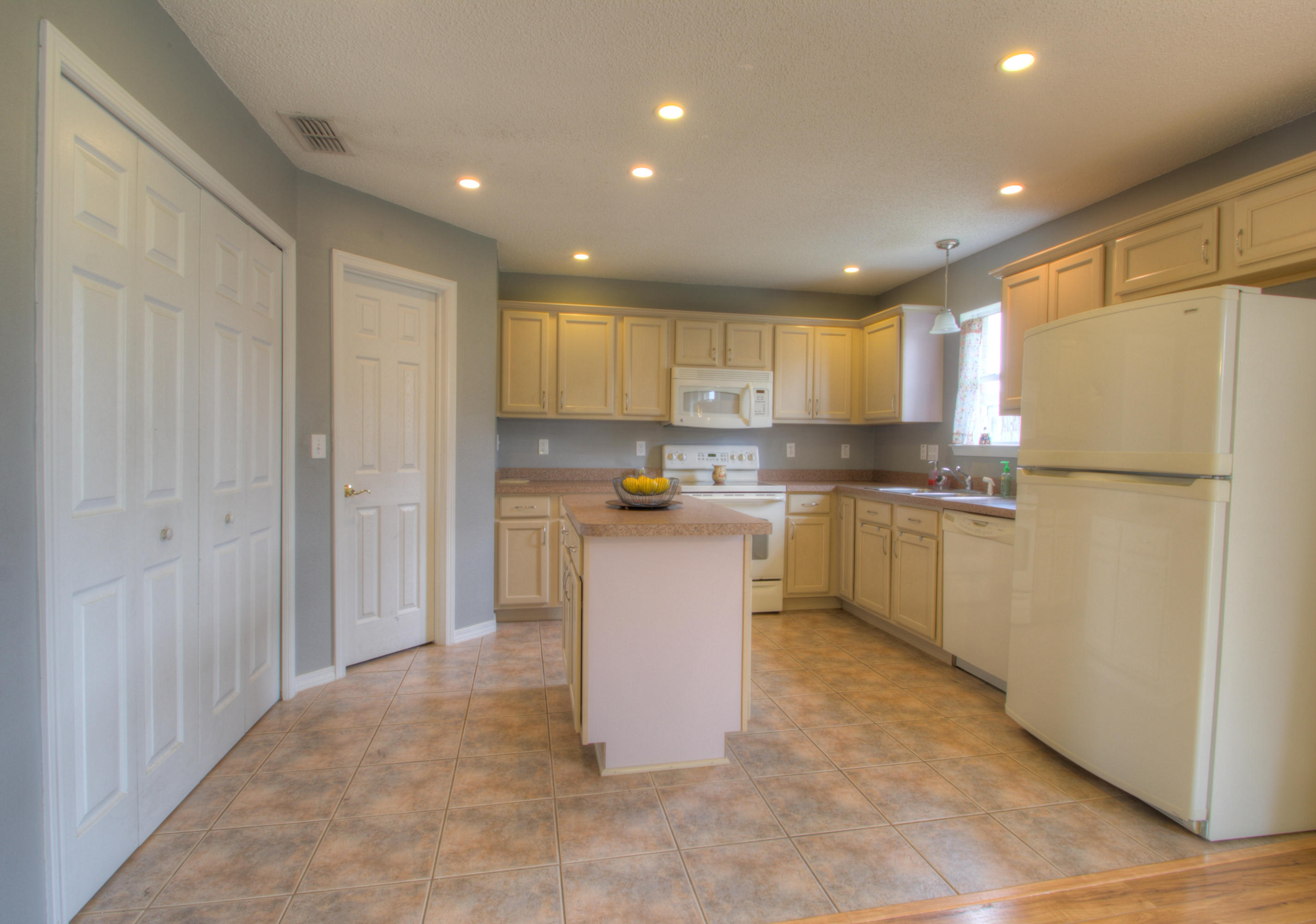 219 Limestone Circle Crestview, FL 32539 - Photo 8 of 31 a kitchen with a refrigerator a sink and cabinets