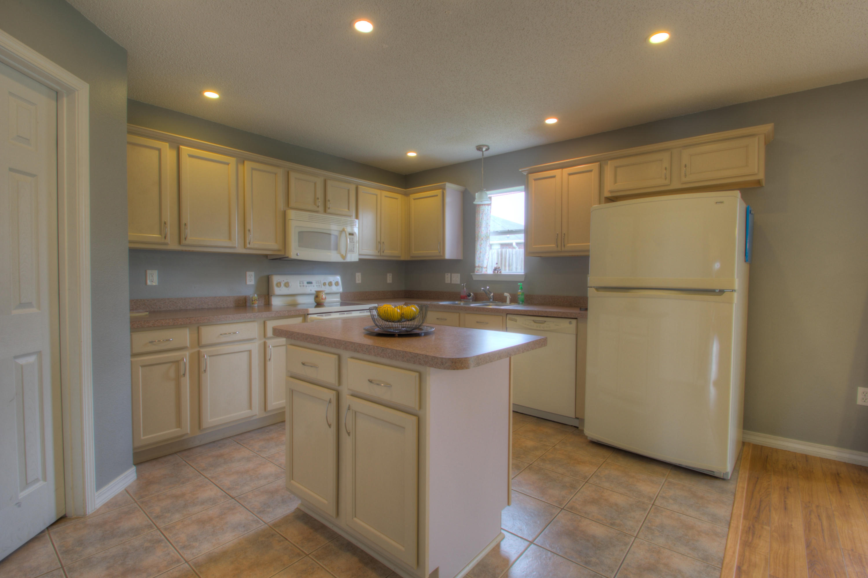 219 Limestone Circle Crestview, FL 32539 - Photo 10 of 31 a kitchen with stainless steel appliances granite countertop a refrigerator sink and white cabinets
