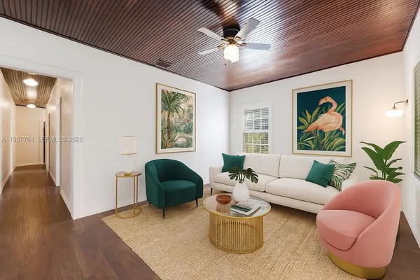 a living room with furniture and a chandelier
