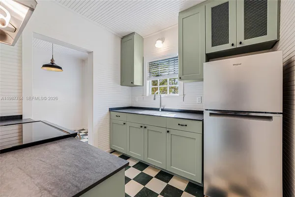 a kitchen with a refrigerator and a sink