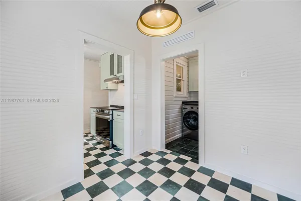 a kitchen with a refrigerator and cabinets