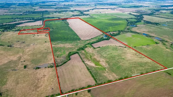 a backyard of a house with a yard and outdoor seating