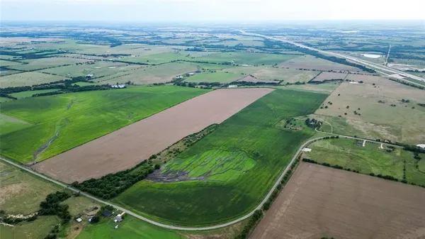 a view of a field with an ocean