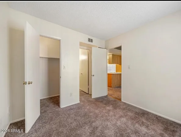 a view of an empty room with an entryway