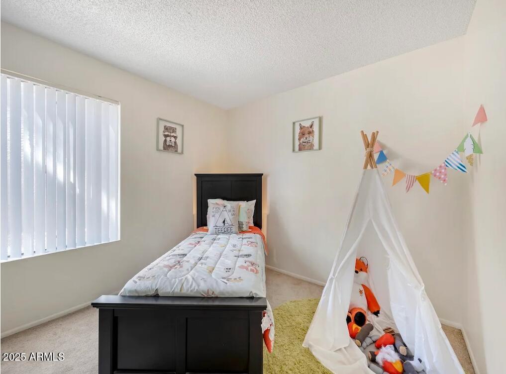 5750 North 59th Avenue, Unit 2 Glendale, AZ 85301 - Photo 5 of 12 a bedroom with a bed and a window