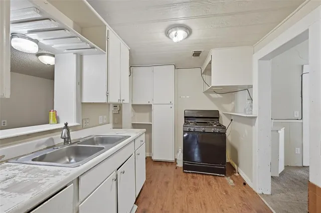 a kitchen with a sink stove and refrigerator