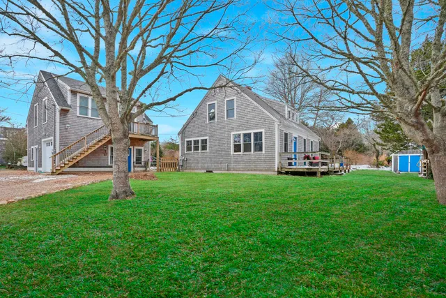 a backyard of a house with table and chairs
