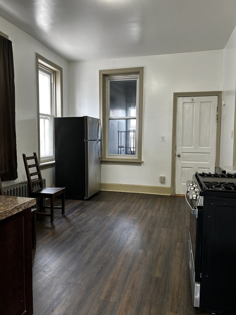 2744 West 23rd Street Chicago, IL 60608 - Photo 5 of 7 a kitchen with a refrigerator and a stove top oven