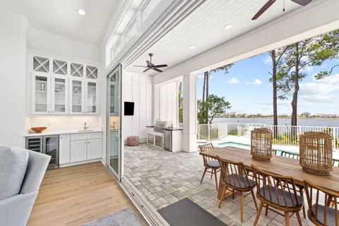 a kitchen with a dining table chairs and wooden floor