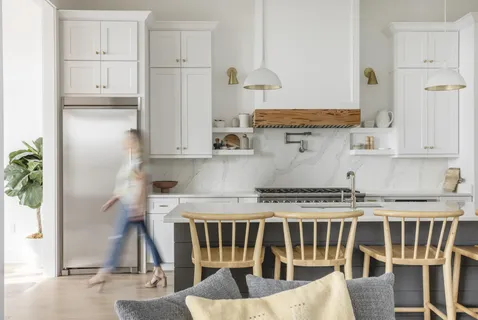 a patio with table and chairs and potted plants