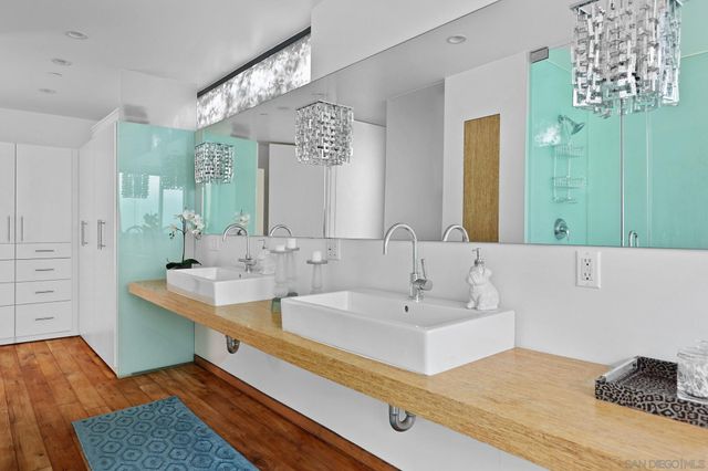 a bathroom with a sink a mirror and shower