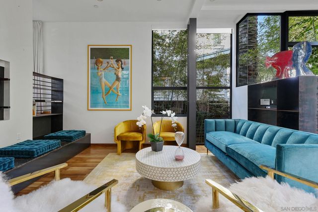 a living room with furniture and a floor to ceiling window