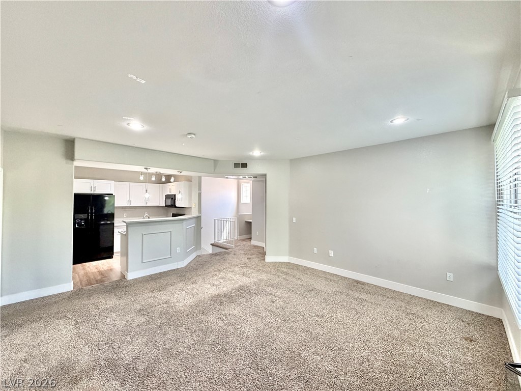 8555 West Russell Road, Unit 2018 Las Vegas, NV 89113 - Photo 7 of 23 An open-concept design seamlessly connects this spacious living area with a contemporary kitchen.