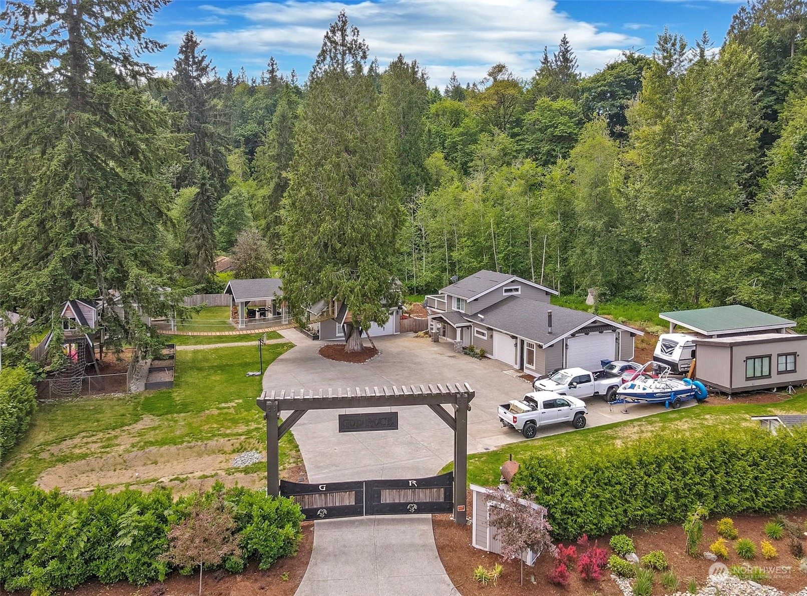 5124 Schwarzmiller Road Lake Stevens, WA 98258 - Photo 1 of 32 an aerial view of a house with garden space and trees all around
