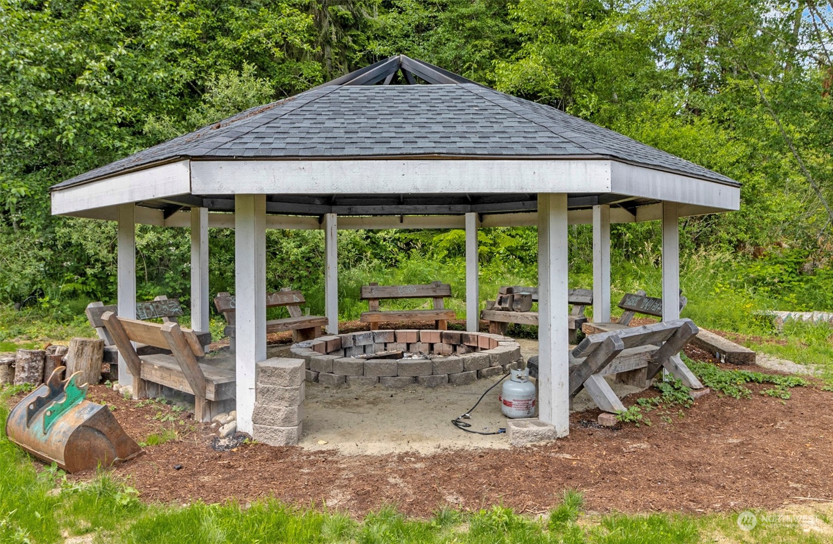 5124 Schwarzmiller Road Lake Stevens, WA 98258 - Photo 30 of 32 a view of a patio with table and chairs under an umbrella
