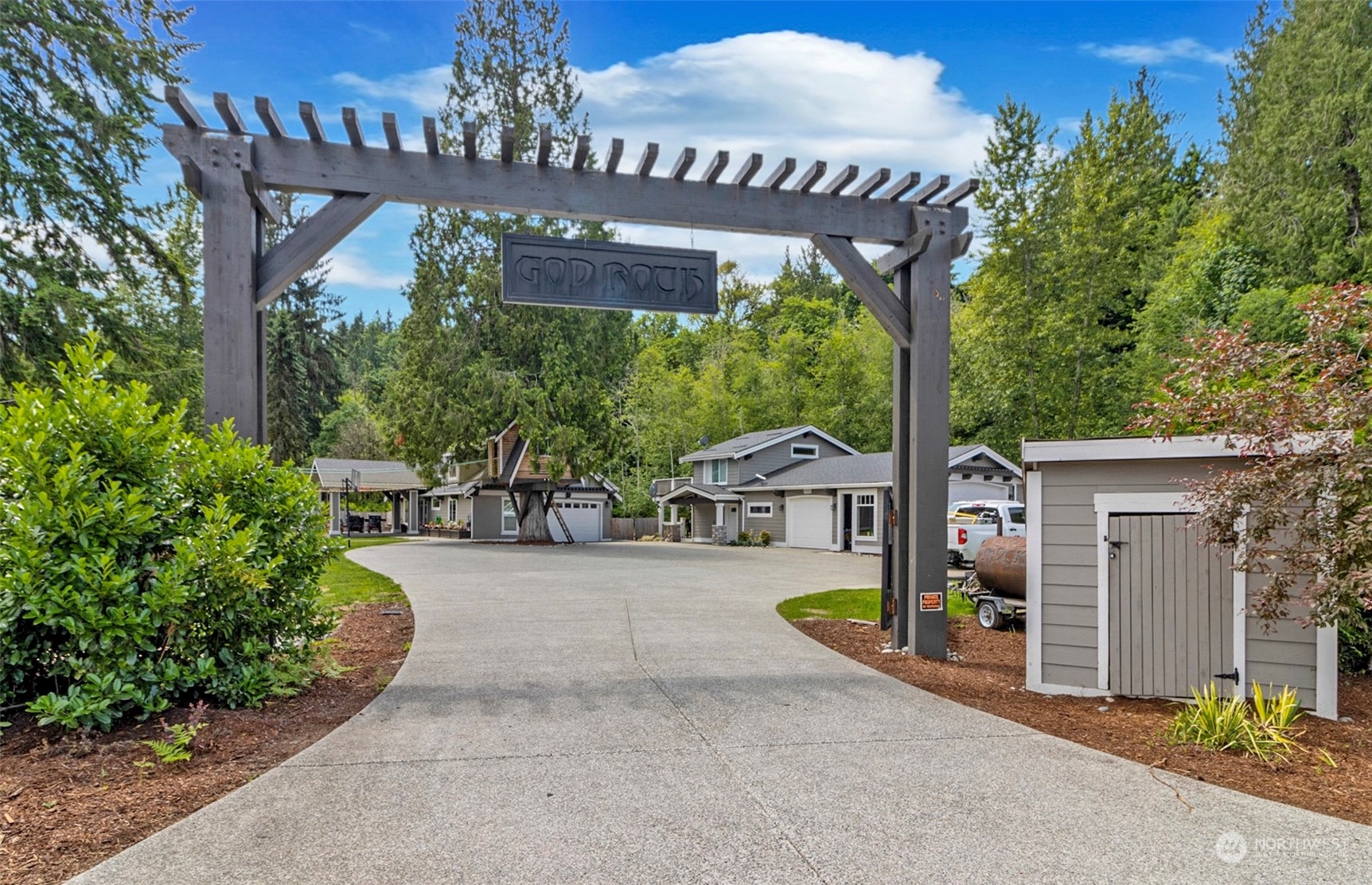 5124 Schwarzmiller Road Lake Stevens, WA 98258 - Photo 3 of 32 a view of a patio with a table and chairs under an umbrella with potted plants