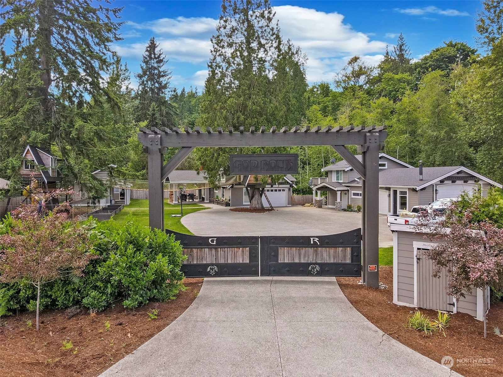 5124 Schwarzmiller Road Lake Stevens, WA 98258 - Photo 32 of 32 a view of a patio with table and chairs plants and large trees