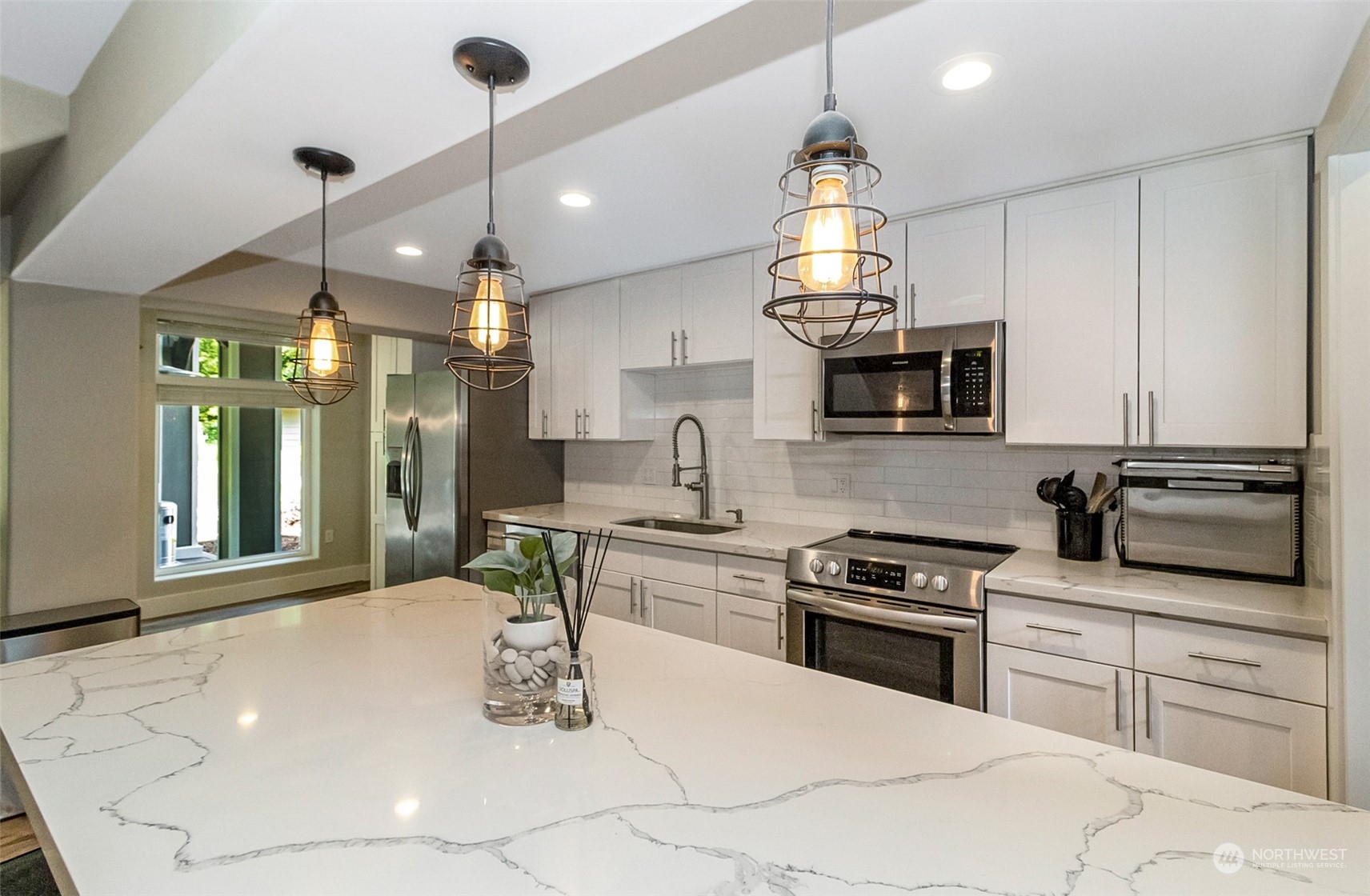 5124 Schwarzmiller Road Lake Stevens, WA 98258 - Photo 10 of 32 a kitchen with kitchen island granite countertop a stove a sink a oven and a chandelier