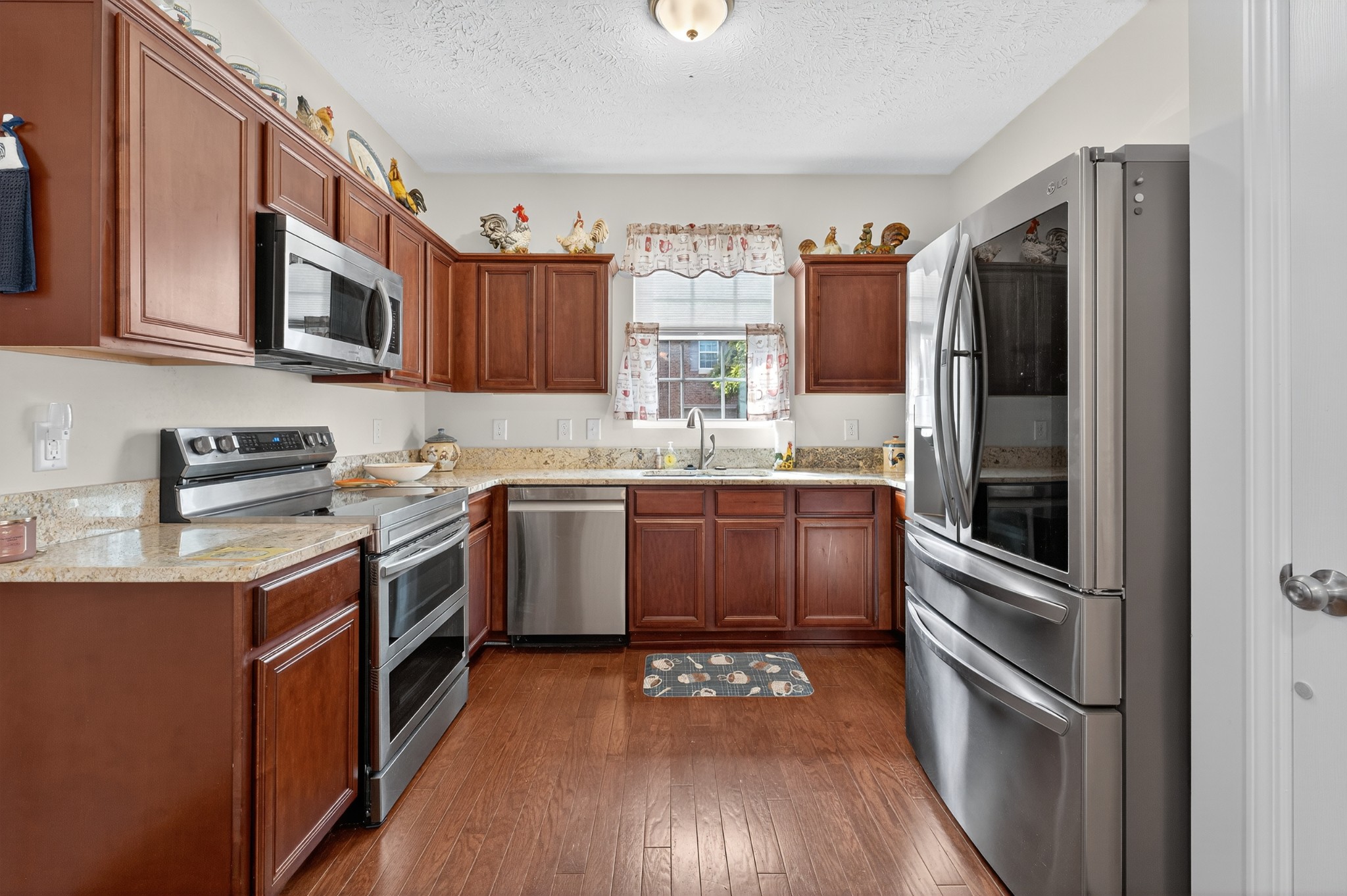 1309 Crown Point Place Nashville, TN 37211 - Photo 11 of 42 a kitchen with granite countertop stainless steel appliances and wooden cabinets