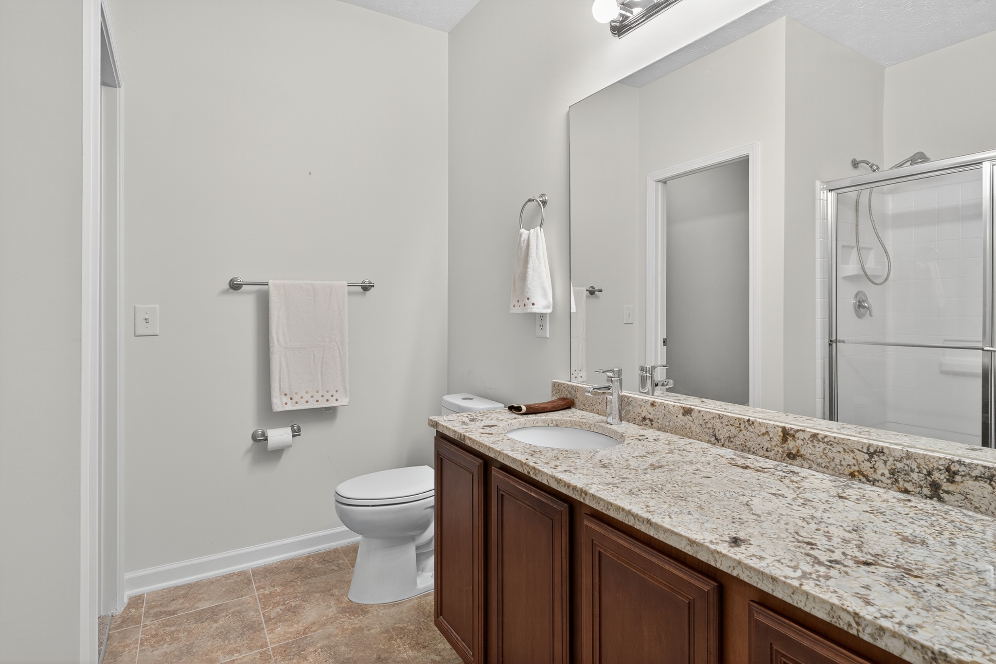 1309 Crown Point Place Nashville, TN 37211 - Photo 22 of 42 a bathroom with a granite countertop sink a toilet and a large mirror