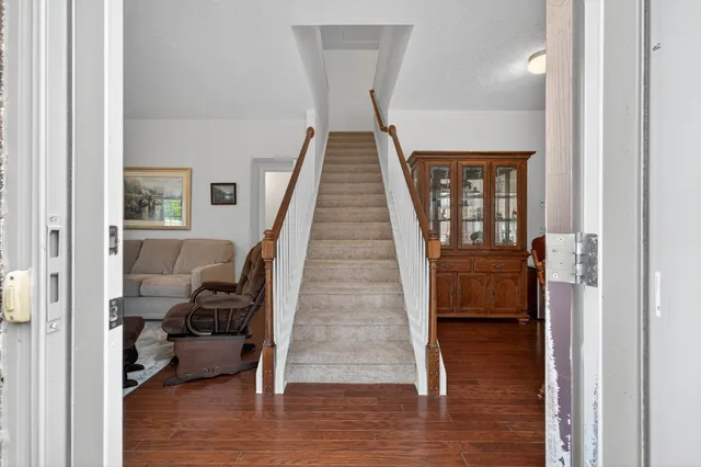 a view of entryway and hall with wooden floor
