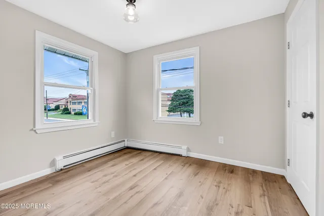 wooden floor in an empty room with a window