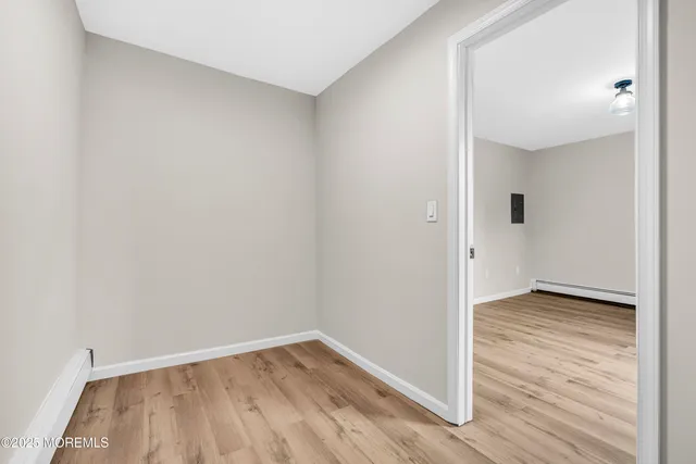 a view of a room with wooden floor
