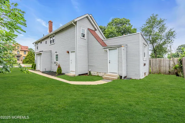 a backyard of a house with plants and barbeque oven