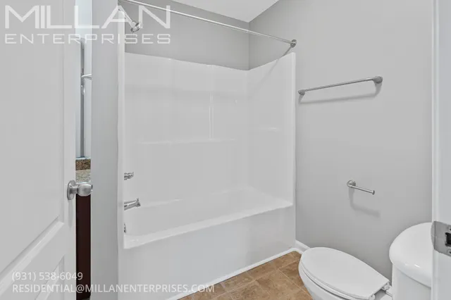 a white toilet sitting next to a bath tub