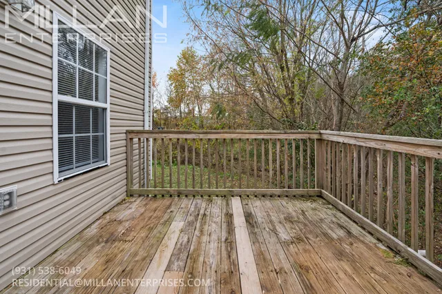 a view of balcony with wooden floor and fence