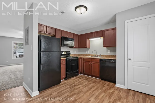 a kitchen with granite countertop stainless steel appliances a refrigerator and a counter space