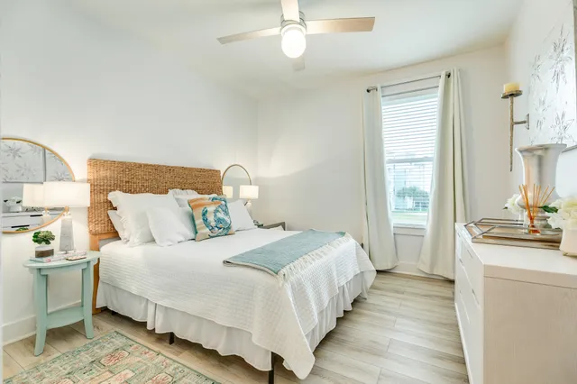 a view of a dining room and livingroom with furniture wooden floor and windows
