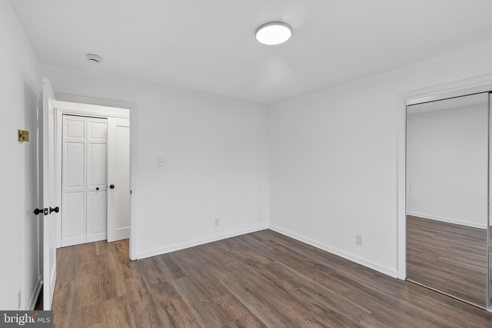 4570 MacArthur Boulevard Northwest, Unit 208 Washington, DC 20007 - Photo 11 of 17 a view of a room with wooden floor and white walls