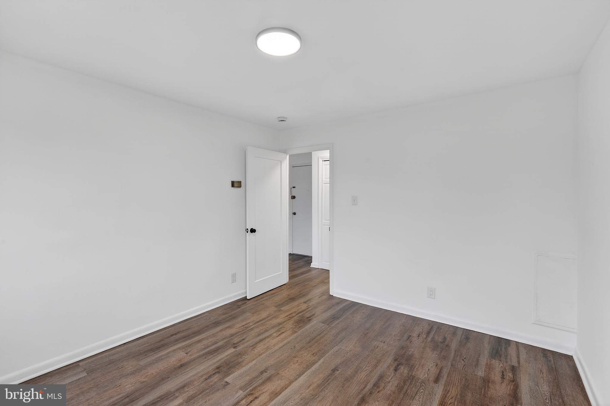 4570 MacArthur Boulevard Northwest, Unit 208 Washington, DC 20007 - Photo 13 of 17 a view of an empty room with wooden floor