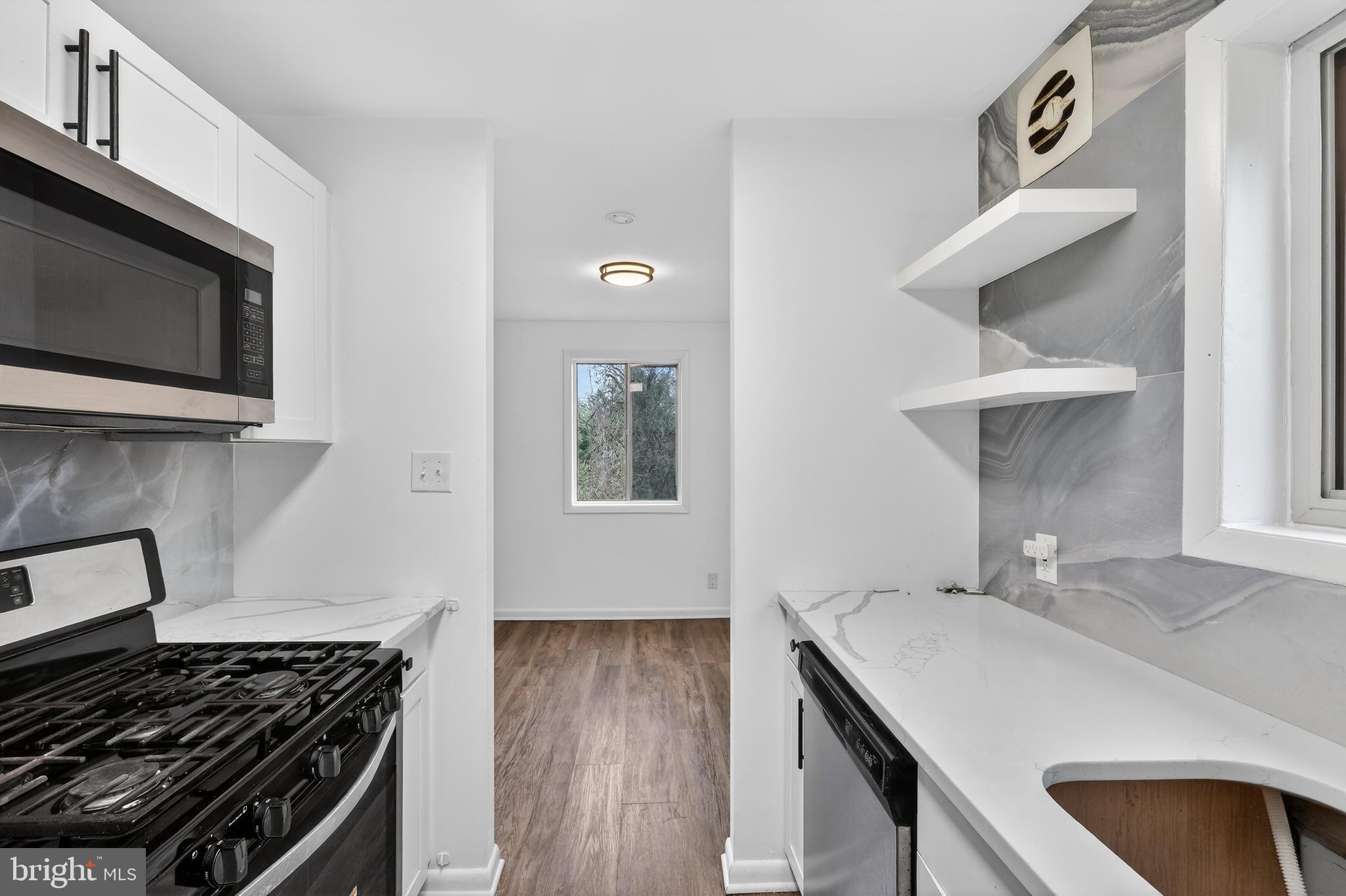 4570 MacArthur Boulevard Northwest, Unit 208 Washington, DC 20007 - Photo 3 of 17 a kitchen with sink and cabinets