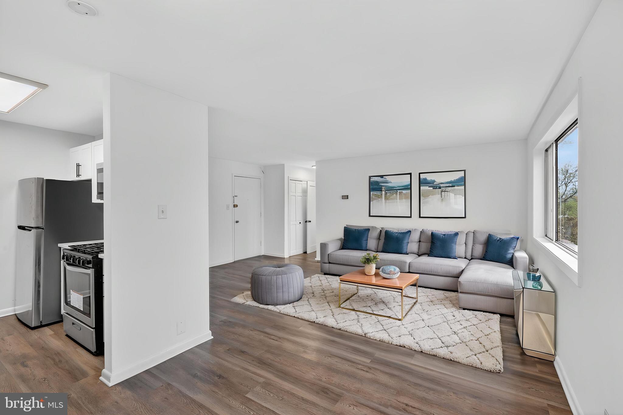 4570 MacArthur Boulevard Northwest, Unit 208 Washington, DC 20007 - Photo 5 of 17 a living room with furniture and a window