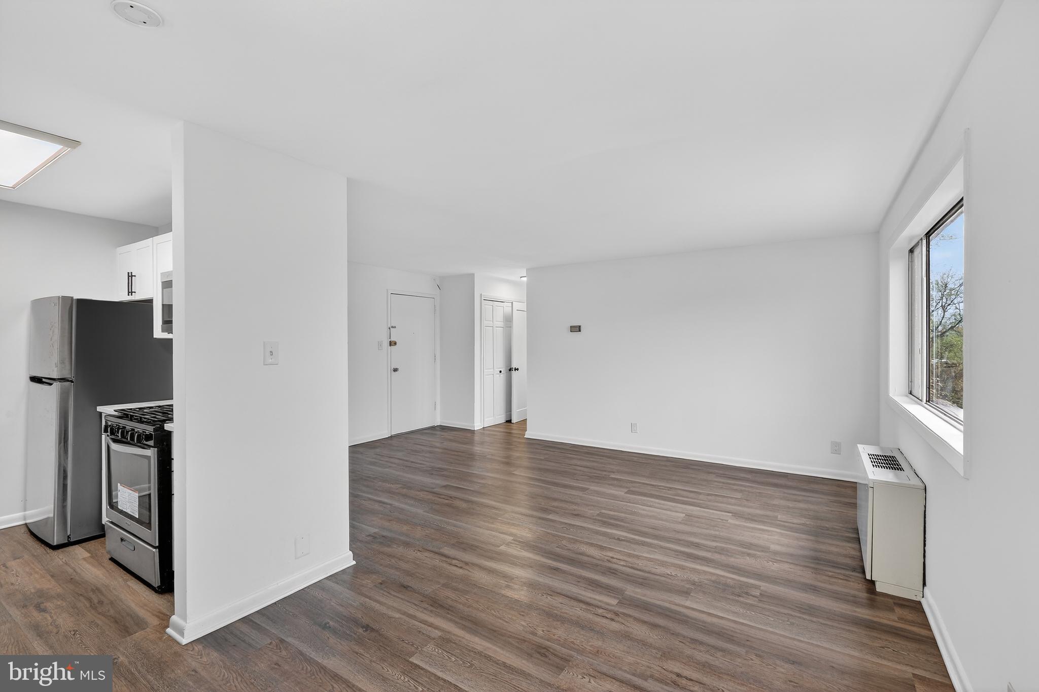 4570 MacArthur Boulevard Northwest, Unit 208 Washington, DC 20007 - Photo 6 of 17 wooden floor in an empty room with a window