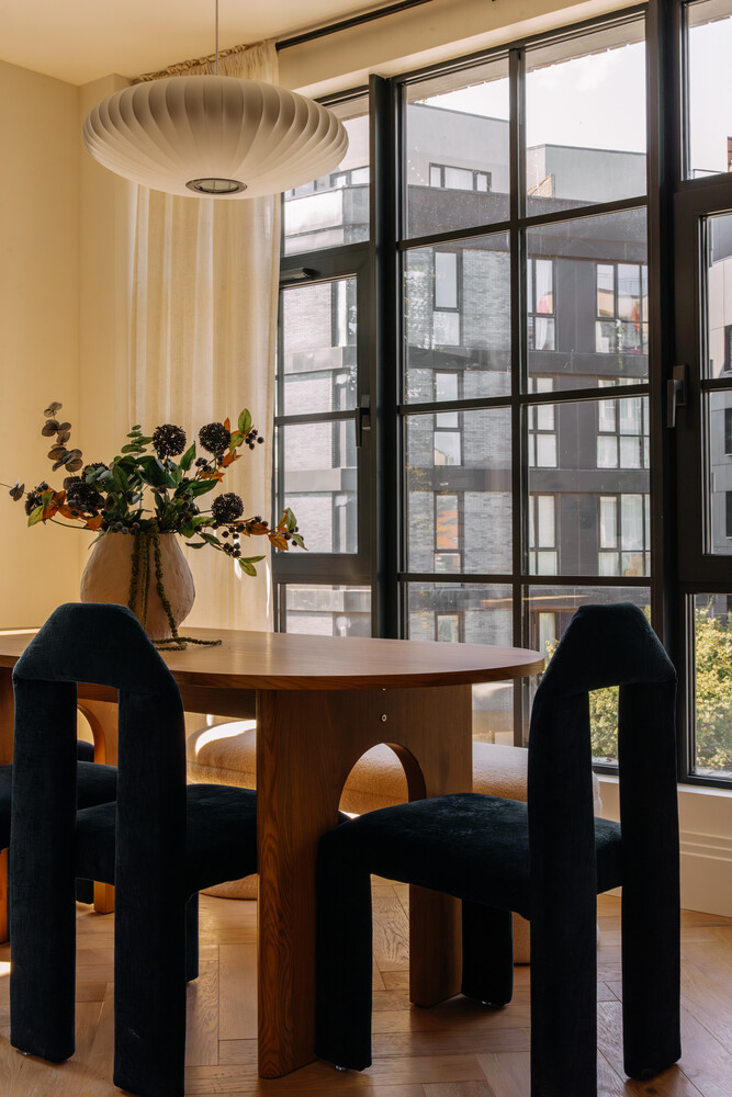 402 Union Avenue, Unit PH2 Brooklyn, NY 11211 - Photo 6 of 23 a table chair sitting in a living room next to a window