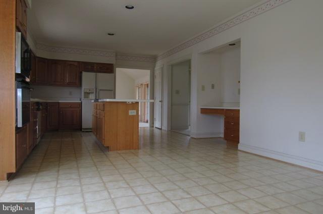 8401 Rocky Springs Road Frederick, MD 21702 - Photo 11 of 23 an empty room with a kitchen