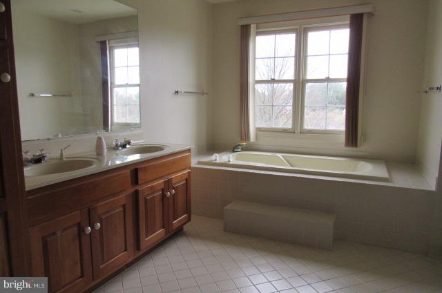 8401 Rocky Springs Road Frederick, MD 21702 - Photo 13 of 23 a spacious bathroom with a tub sink and mirror
