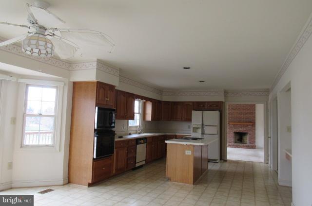 8401 Rocky Springs Road Frederick, MD 21702 - Photo 10 of 23 a kitchen with kitchen island granite countertop stainless steel appliances cabinets a sink and a window
