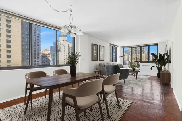 a living room with furniture potted plant and a flat screen tv