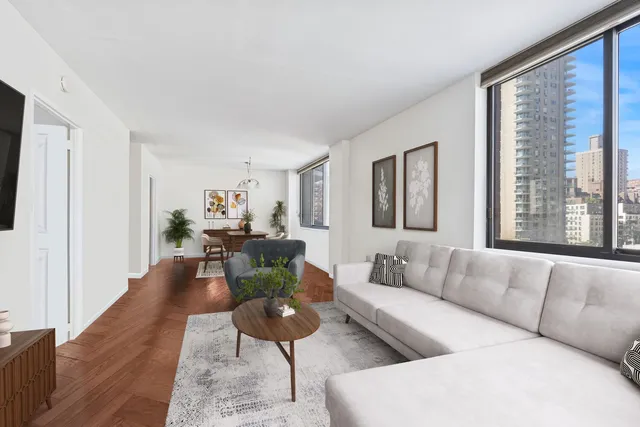 a dining room with furniture a chandelier and wooden floor